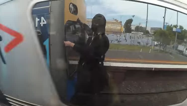 Another member of the Sky High Idiots films himself as he clings onto the side of a speeding carriage. Source: Youtube