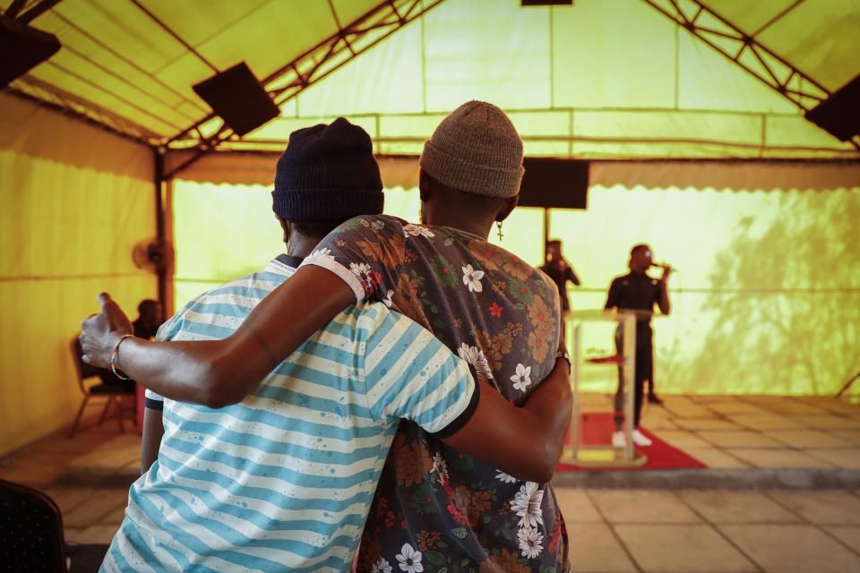 Worshippers embrace during a church service at the Cosmopolitan Affirming Community church, which serves a predominantly LGBTQ congregation, in Nairobi, Kenya, on Sunday, Oct. 17, 2021. In several African countries, bishops aligned with the worldwide United Methodist Church are preparing to join an in-the-works breakaway denomination so they can continue their practice of refusing to recognize same-sex marriage or ordain LGBTQ clergy. (AP Photo/Brian Inganga)