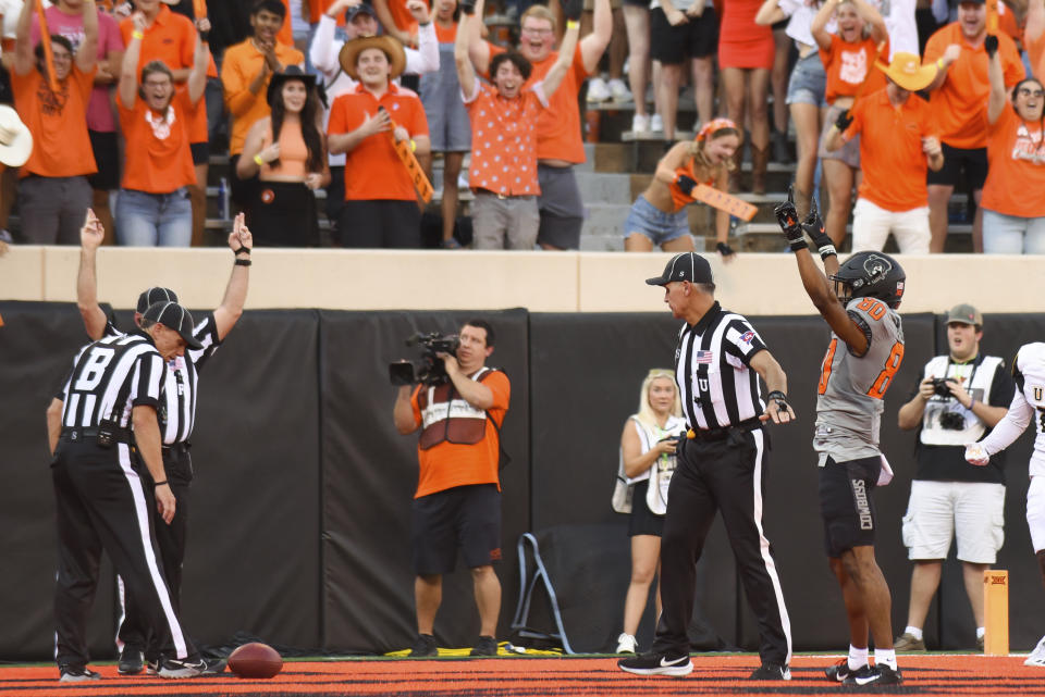 Oklahoma State wide receiver Brennan Presley celebrates a touchdown following the result of a discussion between officials, during the first half of an NCAA college football game against Arkansas-Pine Bluff, Saturday, Sept. 17, 2022, in Stillwater, Okla. (AP Photo/Brody Schmidt)