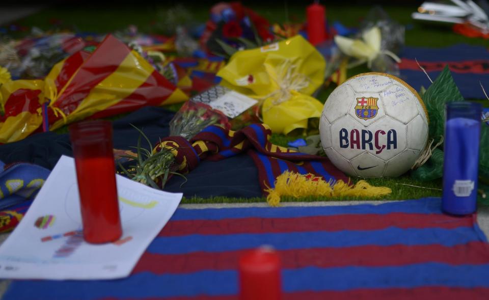 Barcelona football club fan memorabilia is displayed at Camp Nou Stadium in Barcelona, Spain, Saturday, April 26, 2014, as tributes are placed for FC Barcelona soccer former coach, late Tito Vilanova. The Barcelona club announced on their web page Friday April 25, 2014, that Vilanova has died Friday following a long battle with throat cancer. He was 45.(AP Photo/Manu Fernandez)