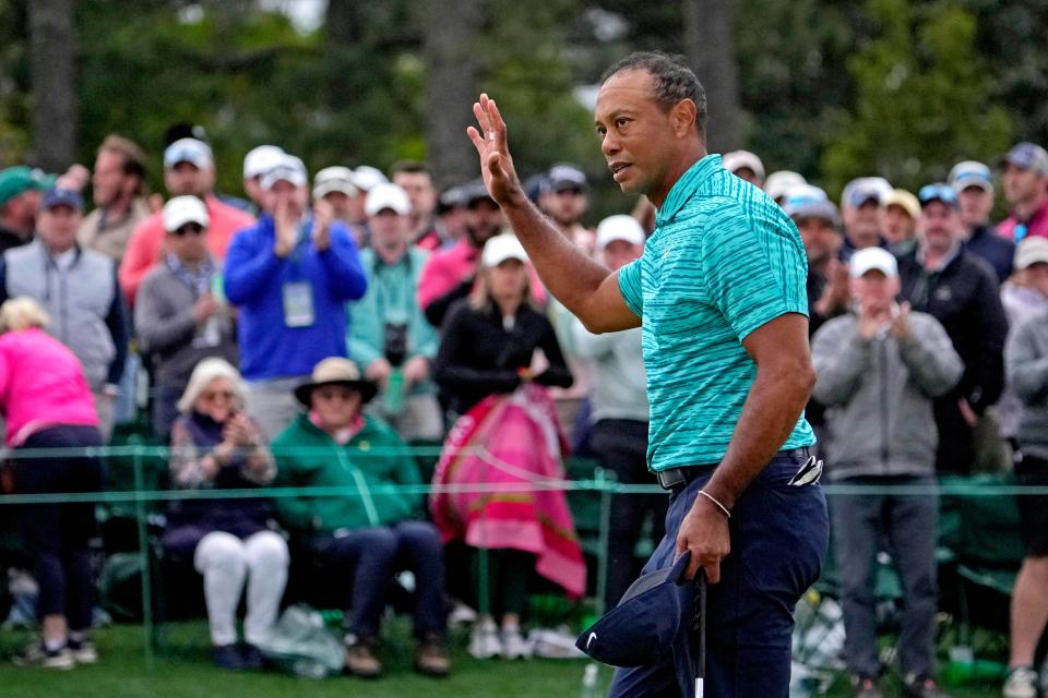Tiger Woods waves to the patrons on the 18th green during the second round of the Masters.