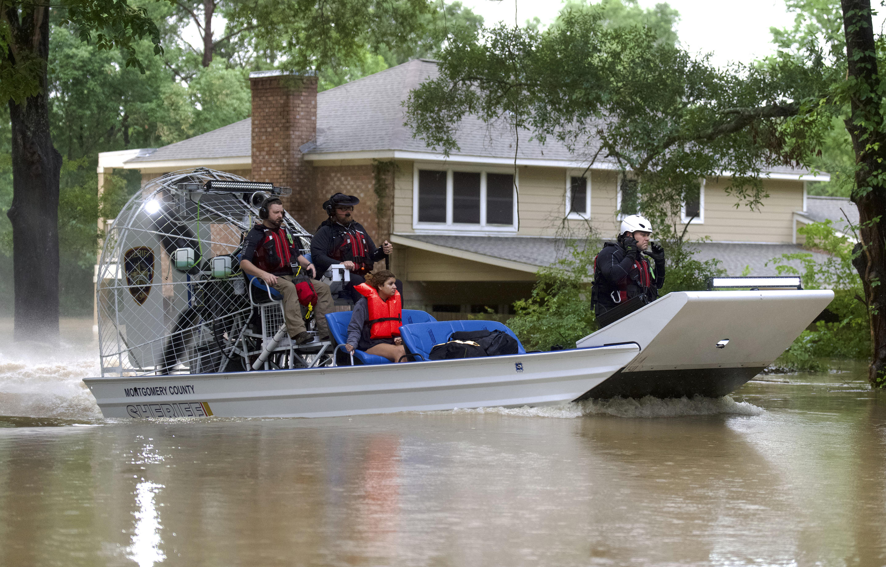 A woman is rescued by airboat.