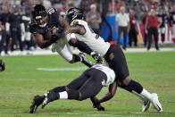 Arizona Cardinals running back TJ Pledger (21) is hit by Baltimore Ravens linebacker Daelin Hayes, right, during the second half of an NFL preseason football game, Sunday, Aug. 21, 2022, in Glendale, Ariz. (AP Photo/Rick Scuteri)
