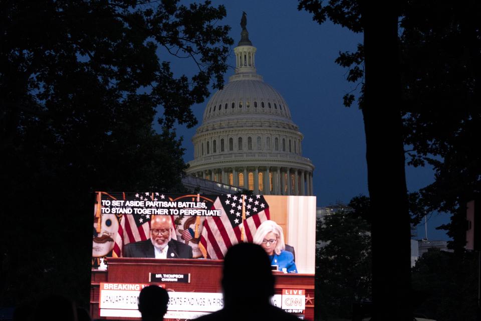 People gather in a park outside of the U.S. Capitol to watch the Jan. 6 House committee investigation in Washington, Thursday, June 9, 2022, as the House committee investigating the Jan. 6 insurrection at the U.S. Capitol holds the first in a series of hearings laying out its findings. (AP Photo/Jose Luis Magana)