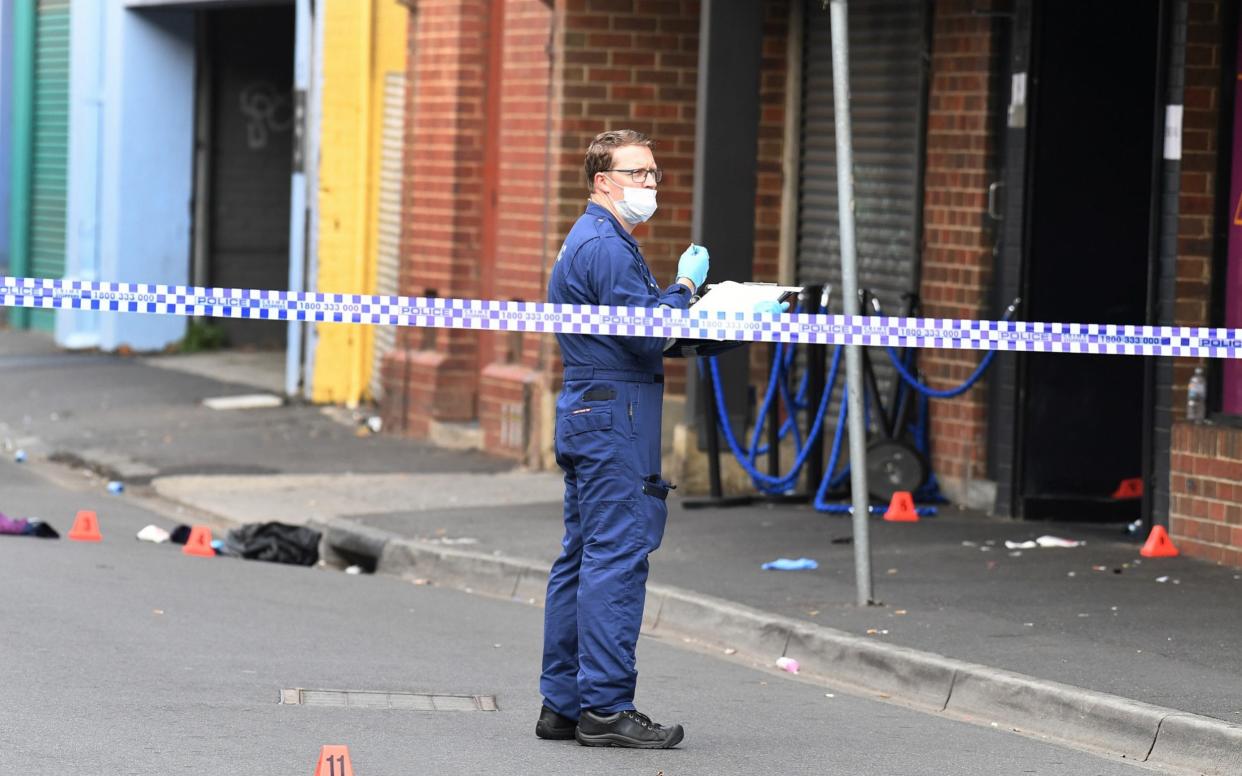 A Victoria Police personnel works at the scene of a multiple shooting outside Love Machine nightclub in Prahran, Melbourne - REUTERS