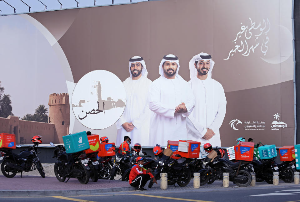 Food-delivery drivers take a break during their shifts in Dubai, United Arab Emirates, May 2, 2022. Food-delivery drivers protesting wage cuts and grueling working conditions went on an extremely rare strike in Dubai on Saturday, April 30, 2022 — a mass walkout that paralyzed one of the country’s main delivery apps and revived concerns about labor conditions in the emirate. The strike ended early Monday, when London-based Deliveroo agreed to restore workers’ pay to $2.79 per delivery instead of the proposed rate of $2.38 amid surging fuel prices. (AP Photo/Isabel Debre)