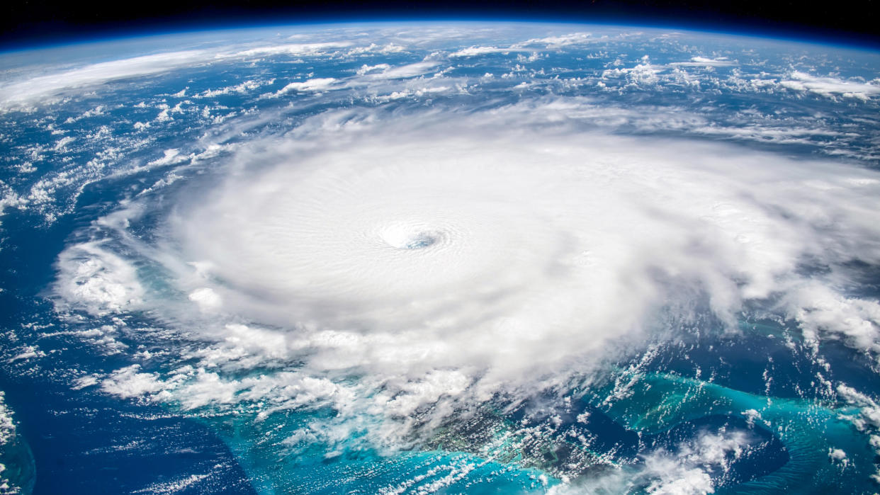  Here we see a huge hurricane in a satellite image against the blue ocean background. 