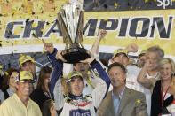 FILE - In this Nov. 18, 2007, file photo, Jimmie Johnson, center, celebrates after winning the NASCAR Nextel Cup Series championship in Homestead, Fla. NASCAR CEO Brian France is at right, and Nextel chief marketing officer Tim Kelly is on left. Jimmie Johnson is the latest NASCAR superstar to climb out of his car, with the seven-time champion announcing Wednesday, Nov. 20, 2019, that 2020 will be his final season of full-time racing. (AP Photo/Alan Diaz, File)
