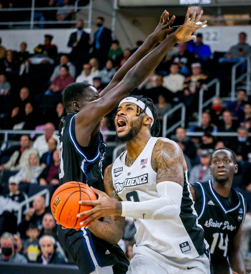 Providence College center Nate Watson, who finished with 23 points, goes to the basket past St. Peter's Fousseyni Drame during Saturday's game at the Dunkin' Donuts Center.