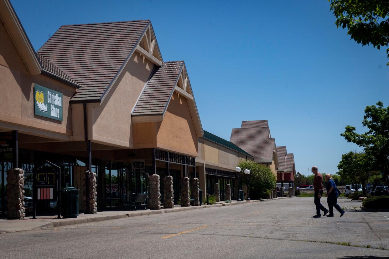 Customers make their way to Show Who You Are Christian Store at the largely vacant Outlets at Loveland on Thursday, May 26, 2022, in Loveland, Colo.