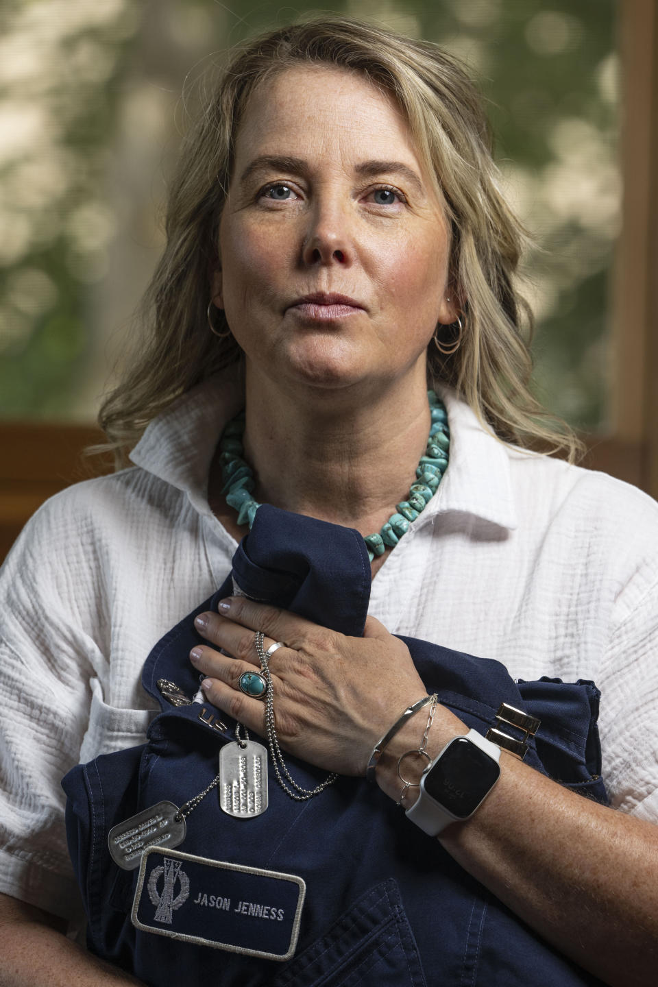 Doreen Jenness, the widow of Air Force Capt. Jason Jenness, sits for a portrait during an interview with the Associated Press at her home in Missoula, Mont., Aug. 26, 2023. Capt. Jenness was a Malmstrom missileer who died of non-Hodgkin lymphoma in 2001 at the age of 31. (AP Photo/Tommy Martino)