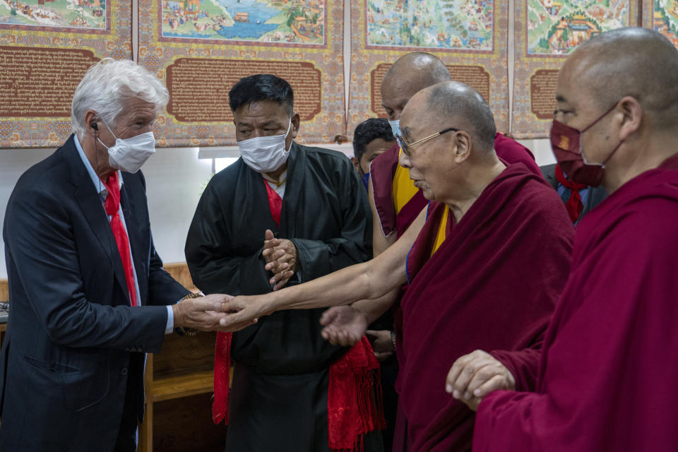 Tibetan spiritual leader the Dalai Lama greets Hollywood actor Richard Gere, left, as he leaves after inaugurating a museum containing the archives of the institution of the Dalai Lama in Dharmsala, India, Wednesday, July 6, 2022. Exile Tibetans also celebrated their spiritual leader's 87th birthday today. (AP Photo/Ashwini Bhatia)