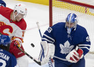 Calgary Flames' Matthew Tkachuk (19) and Toronto Maple Leafs goaltender David Rittich (33) battle for the puck during the third period of an NHL hockey game Tuesday, April 13, 2021 in Toronto. (Frank Gunn/Canadian Press via AP)