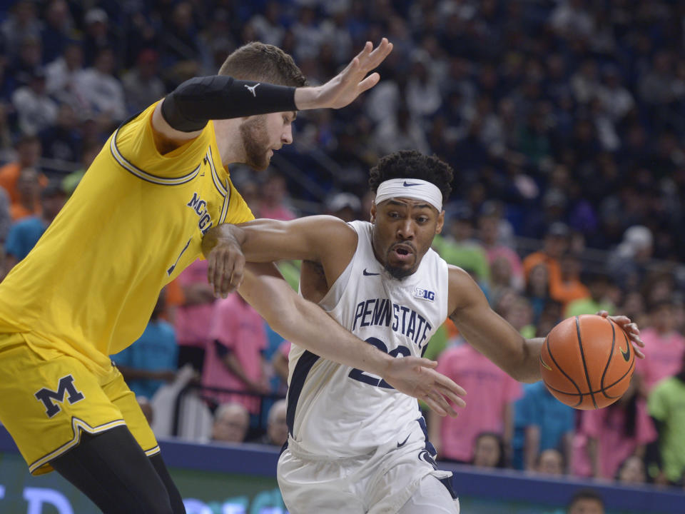 Penn State's Jalen Pickett drives to the basket on Michigan's Hunter Dickinson during the first half of an NCAA college basketball game, Sunday, Jan. 29, 2023, in State College, Pa. (AP Photo/Gary M. Baranec)