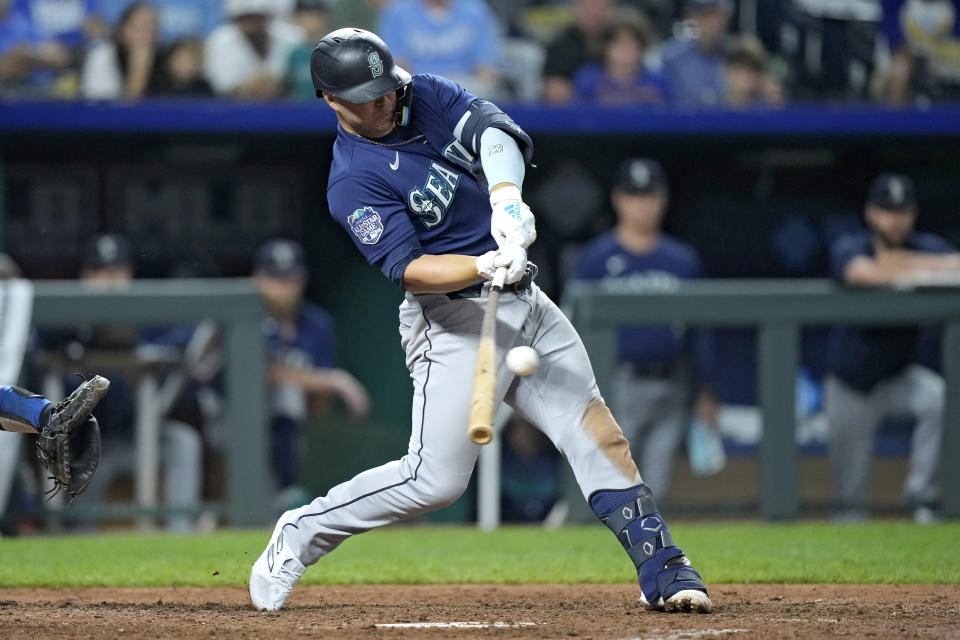 Seattle Mariners' Ty France hits a two-run single during the 10th inning of a baseball game against the Kansas City Royals Tuesday, Aug. 15, 2023, in Kansas City, Mo. The Mariners won 10-8 in 10 innings. (AP Photo/Charlie Riedel)