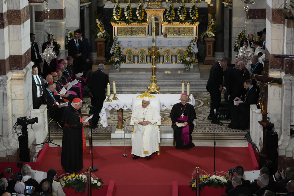 Pope Francis listens to a speech by Cardinal Jean-Marc Aveline at the Notre Dame de la Garde Basilica, during a Marian prayer with the diocesan clergy, in Marseille, France, Friday, Sept. 22, 2023. Francis, during a two-day visit, will join Catholic bishops from the Mediterranean region on discussions that will largely focus on migration. (AP Photo/Alessandra Tarantino)
