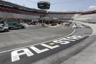 Work goes on in the infield behind an All-Star Race logo before the NASCAR All-Star auto race at Bristol Motor Speedway in Bristol, Tenn, Wednesday, July 15, 2020. (AP Photo/Mark Humphrey)