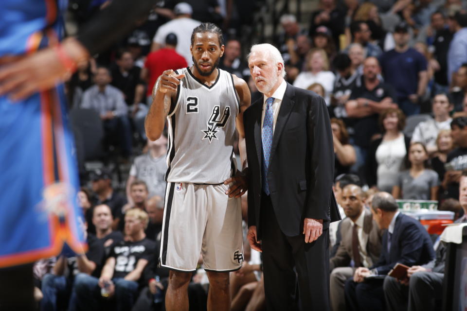 Kawhi Leonard and Gregg Popovich confer during a game in 2016. (Getty)