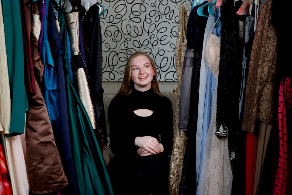 Isabella Mach, a junior at Northville High School in Northville with some of the many prom dresses in her home in Northville on Friday, April 5, 2024. Mach started up her own nonprofit, “A Princess PROMise,” with the goal to donate gently used prom dresses, shoes and other items for high schoolers who might not be able to afford dresses which can cost in the hundreds of dollars. Since getting the word out about asking for donated dresses she has received 54 dresses, 13 pairs of shoes, 7 purses and 9 suits.