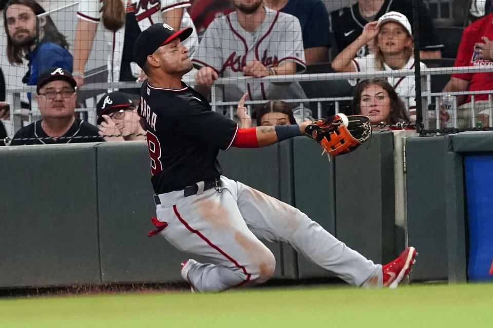 Washington Nationals right fielder Gerardo Parra (88) makes a catch in foul territory to retire Atlanta Braves' Austin Riley during the sixth inning of a baseball game Friday, Aug. 6, 2021, in Atlanta. (AP Photo/John Bazemore)