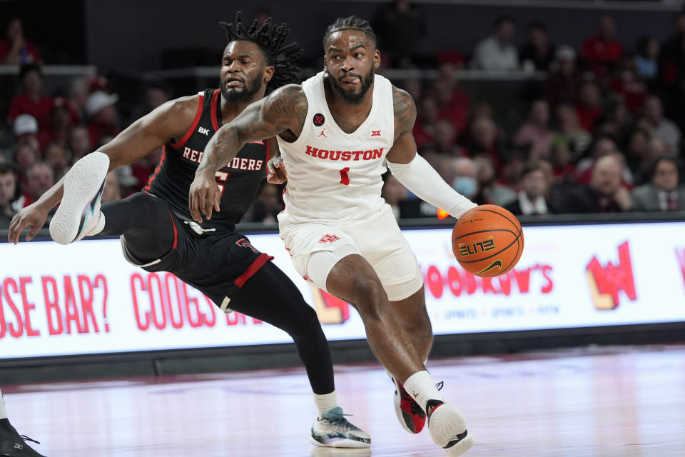 Houston's Jamal Shead (1) drives to the basket as Texas Tech's Joe Toussaint defends during the second half of an NCAA college basketball game Wednesday, Jan. 17, 2024, in Houston. (AP Photo/David J. Phillip)