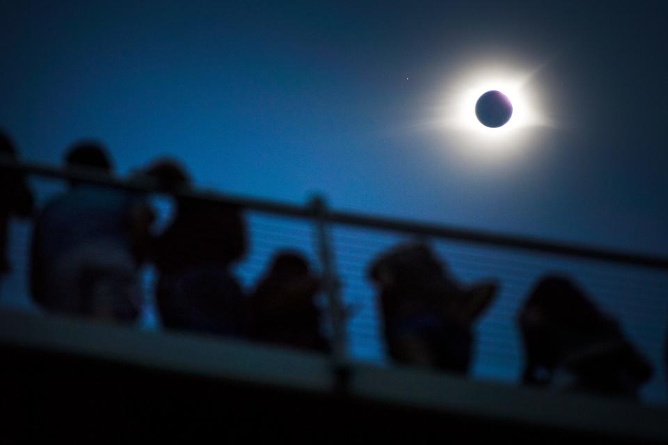 The solar eclipse is in totality over Falls Park Bridge in Greenville on Monday, August 21, 2017. 