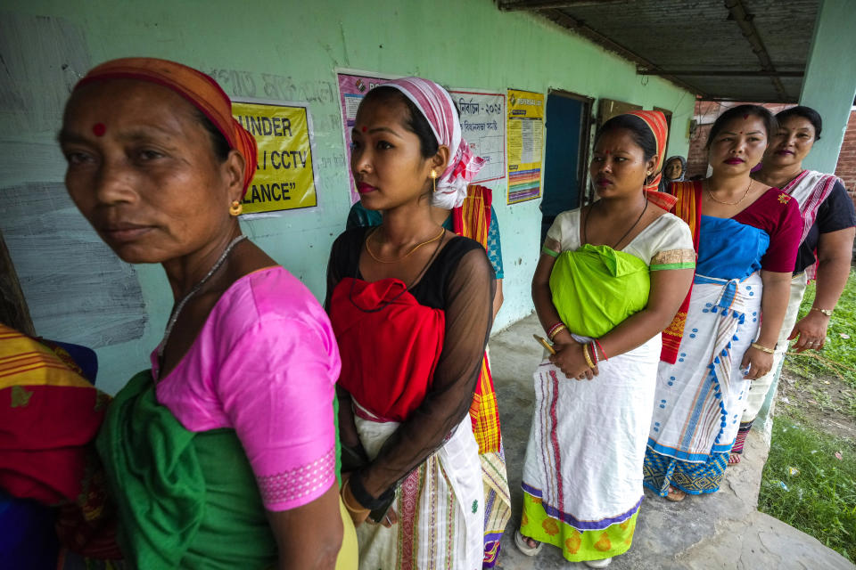 Deori tribal women stand in a queue to cast their vote during the first round of polling of India's national election in Jorhat, India, Friday, April 19, 2024. Nearly 970 million voters will elect 543 members for the lower house of Parliament for five years, during staggered elections that will run until June 1. (AP Photo/Anupam Nath)