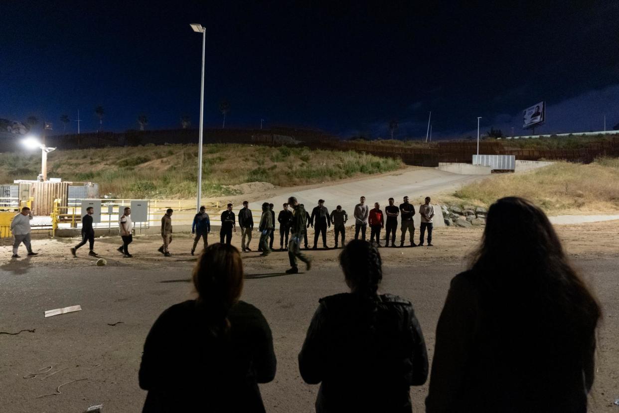 <span>People lined up along the border walls separating Tijuana, Mexico, and San Diego, to apply for asylum on 7 May.</span><span>Photograph: Ryan Sun/AP</span>