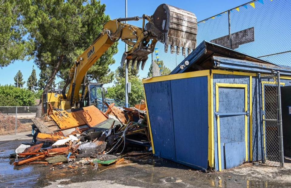 Fresno Mayor Jerry Dyer uses an excavator to demolish the 60-year-old field house at Bakman Field in Fresno’s Sunnyside area on Tuesday, July 11, 2023. Sunnyside Little Leaguers hope to play on a new field with a new snack bar, press box and restroom facility when the project is completed next spring.