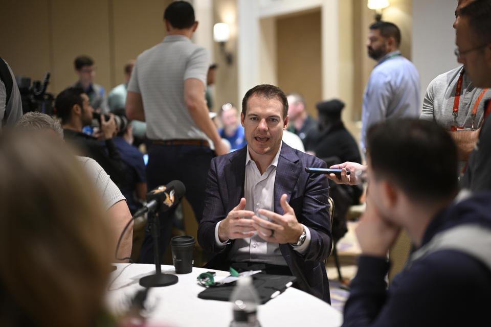 Minnesota Vikings head football coach Kevin O'Connell, center, talks with reporters during an NFC coaches availability at the NFL football owners meetings, Tuesday, March 26, 2024, in Orlando, Fla. (AP Photo/Phelan M. Ebenhack)