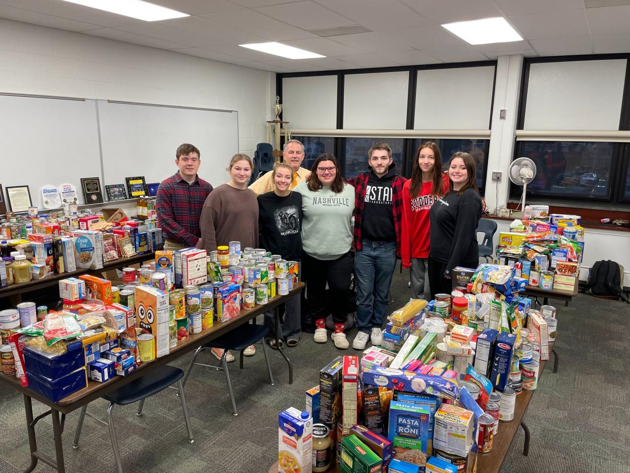 Port Clinton High School DECA collected thousands of items to be donated to St. Vincent de Paul Food Pantry. In back is Bill Hollister, PCHS Marketing Educator and DECA Adviser. In front, from left, are Joseph Apple, Olivia Rodgers, Brigitte Schroeder, Mia Sanchez, Jase Bee, Christen Sayre and Kenzie Brotherton.