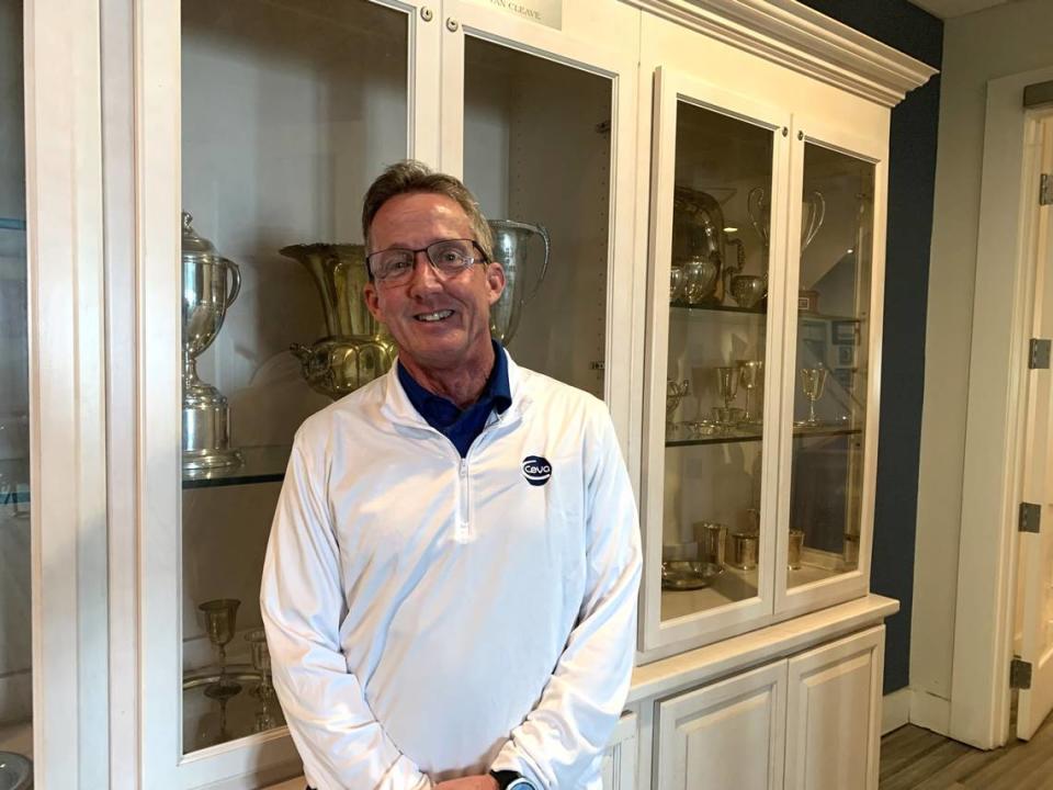 Tim Manuel, 2024 commodore at the Biloxi Yacht Club, stands near a case of trophies and awards. The building was sold, but the yacht club will remain there for at least a year.