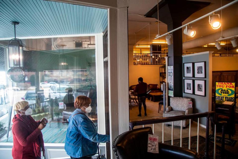 Customers shop at Whitley Furniture Gallery in downtown Zebulon Tuesday, Jan. 25, 2022. The store is going out of business after four generations of family operation and the city block it covers will likely be redeveloped.