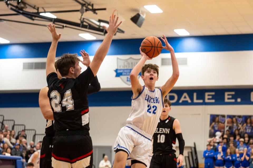 LaVille's Collin Czarnecki (22) goes up for a shot as John Glenn's Carson Krueger (24) defends during the John Glenn-LaVille high school Bi-County championship basketball game on Saturday, January 21, 2023, at LaVille High School in Lakeville, Indiana.