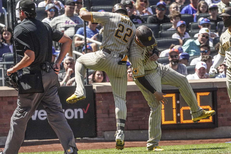 San Diego Padres Juan Soto, left, celebrates his two run homer with teammate Manny Machado, during the first inning of a baseball game against New York Mets, Wednesday, April 12, 2023, in New York. (AP Photo/Bebeto Matthews)