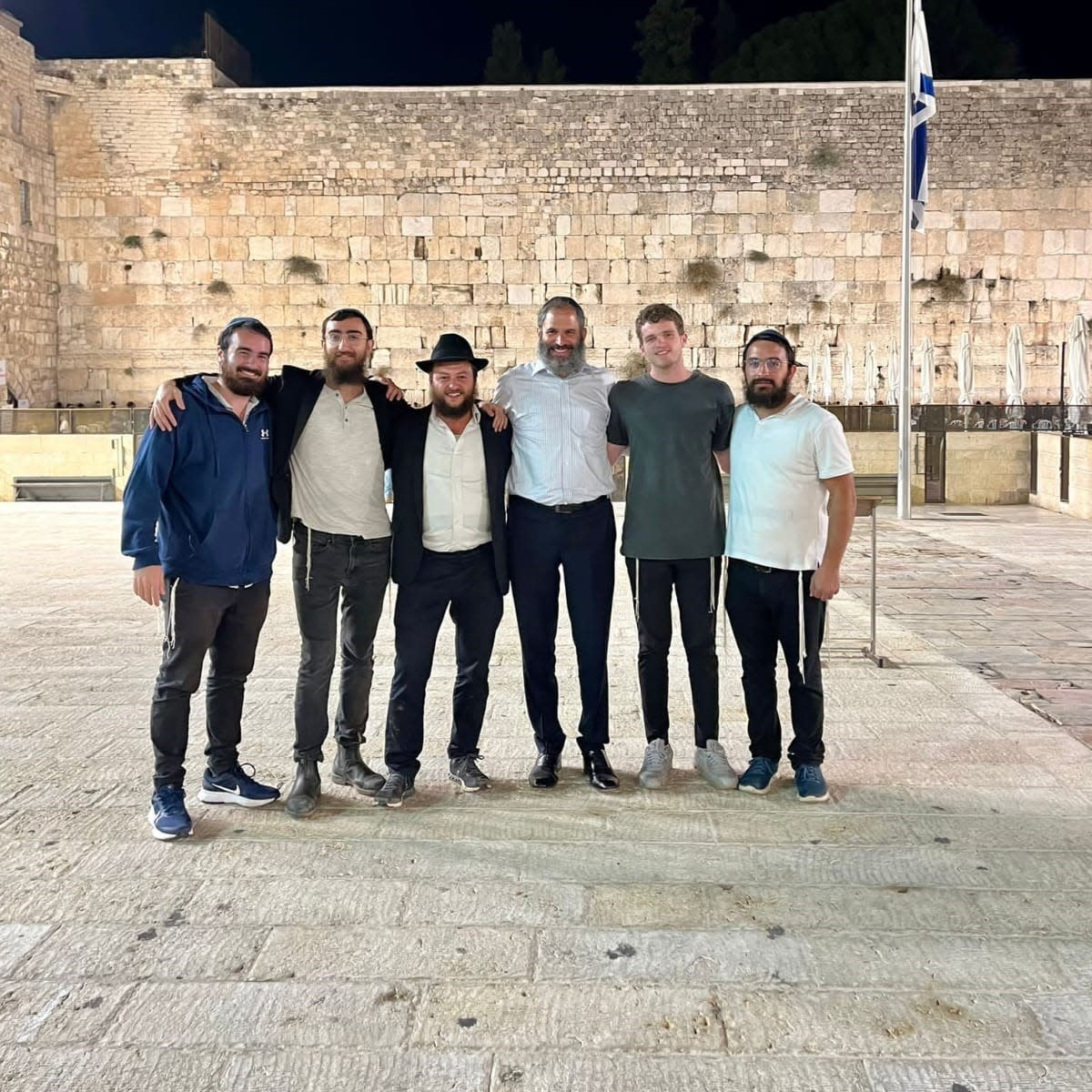 Rabbis Leibel Shmotkin, from left, Shneor Minsky, Yoseph Rice and Moshe Scheiner, and congregants Uziel Scheiner, and Yossi Dworcan stand in front of the Wailing Wall in Jerusalem last week during the final day of a rabbinic mission to Israel.