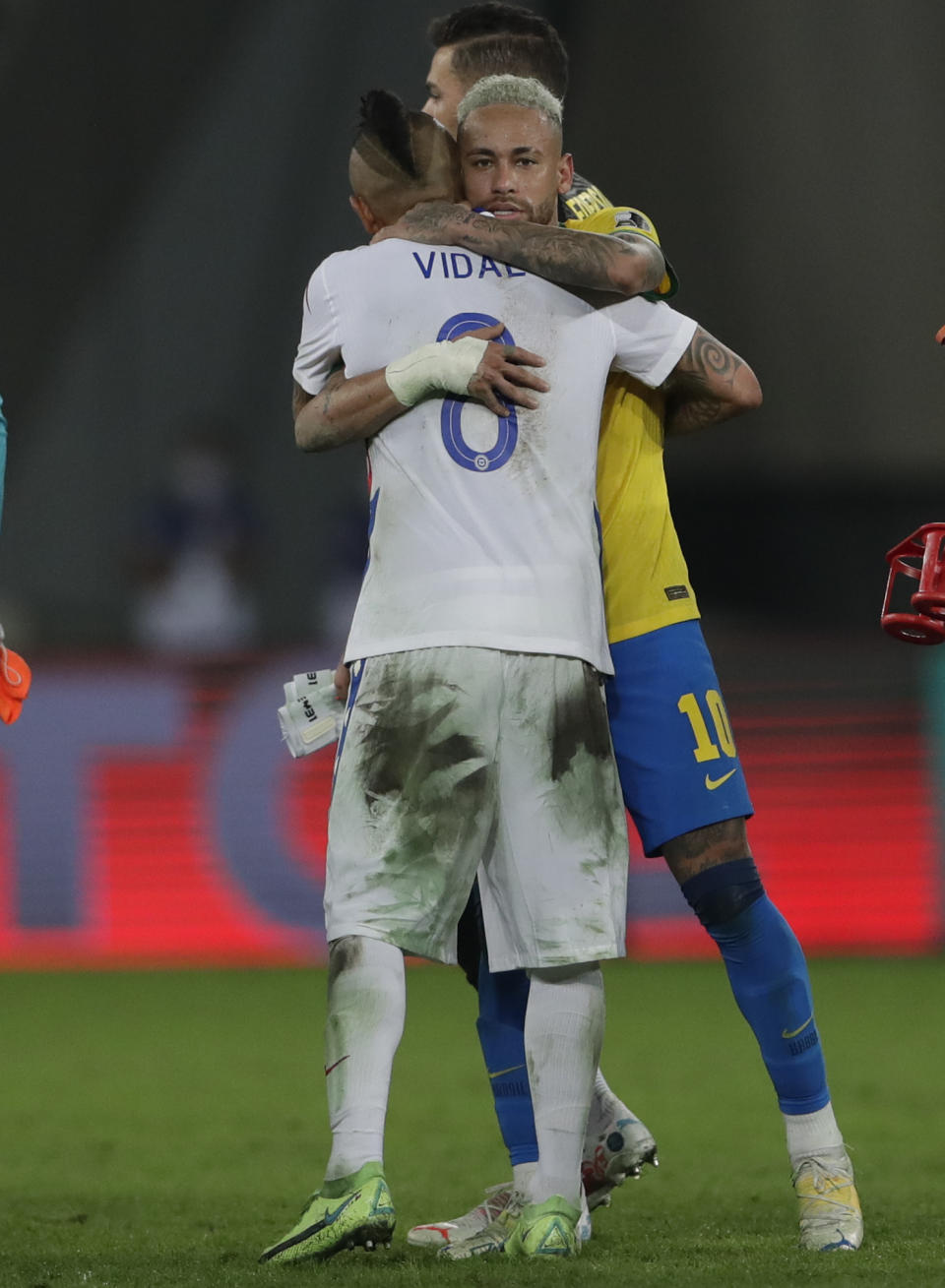Chile's Arturo Vidal, 8, embraces Brazil's Neymar at the end of a Copa America quarterfinal soccer match at the Nilton Santos stadium in Rio de Janeiro, Brazil, Friday, July 2, 2021. Chile lost to Brazil 0-1. (AP Photo/Silvia Izquierdo)