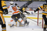The puck bounces out after Philadelphia Flyers' Joel Farabee (86) scores on Pittsburgh Penguins' Tristan Jarry, bottom, during the second period of an NHL hockey game, Tuesday, March 2, 2021, in Pittsburgh. (AP Photo/Keith Srakocic)