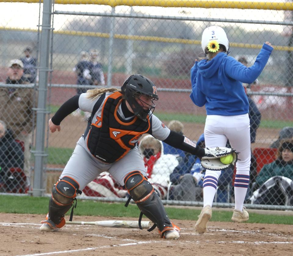 Riley Sweitzer of Lake just beats the tag of Massillon catcher Ahna Els at home to score during the Duhon Softball Tournament at Genshaft Park in Massillon. 