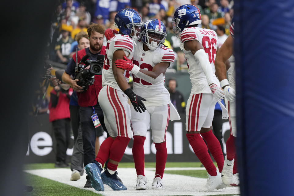 New York Giants running back Saquon Barkley (26) celebrates a touchdown during the second half of an NFL football game against the Green Bay Packers at the Tottenham Hotspur stadium in London, Sunday, Oct. 9, 2022. (AP Photo/Alastair Grant)