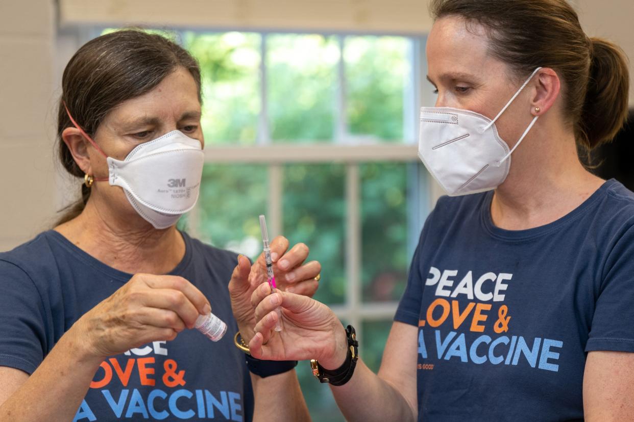 Nurses Debbie Black and Rachel Lee double check a COVID-19 vaccine dose for a child during a vaccine clinic in Hamilton, Massachusetts, on Sept. 9.