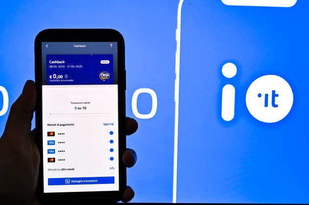 TURIN, ITALY - DECEMBER 08: In this photo illustration -  A hand interacts with the IO app Cashback on a smartphone on December 08, 2020 in Turin, Italy. the Cashback Plan introduced by the Italian government, to encourage Christmas purchases through the IO app, will make it possible to recover up to 150 euros on expenses made by 31 December with credit cards and debit cards at physical stores. Italian regions lowered their COVID-19 measures as contagions are dropping in the whole country and the Government is looking at restraining travels during the Christmas time. (Photo by Diego Puletto/Getty Images) (Photo: Diego Puletto via Getty Images)