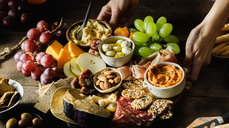 Person holding charcuterie board