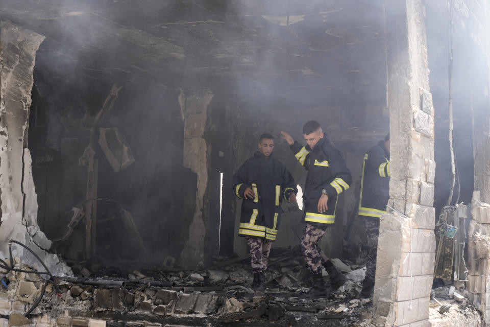 Palestinian firefighters work in the rubble of a home destroyed in an Israeli military operation in the West Bank city of Jenin, Friday, July 5, 2024. The Israeli military said Friday it was conducting counterterrorism activity that included an airstrike in the area of the West Bank city of Jenin. Palestinian authorities said five people were killed. (AP Photo/Majdi Mohammed)