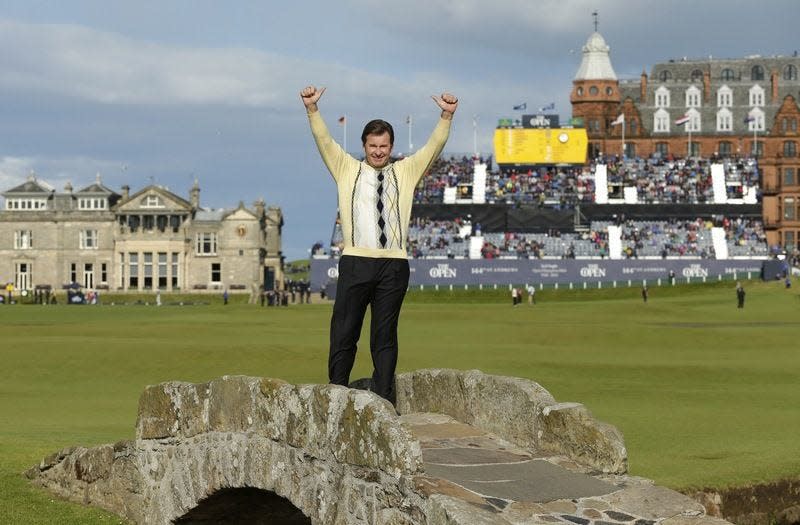 Nick Faldo waves to fans from the Swilcan Bridge at St. Andrews Old Course in 2015, during his final British Open round.