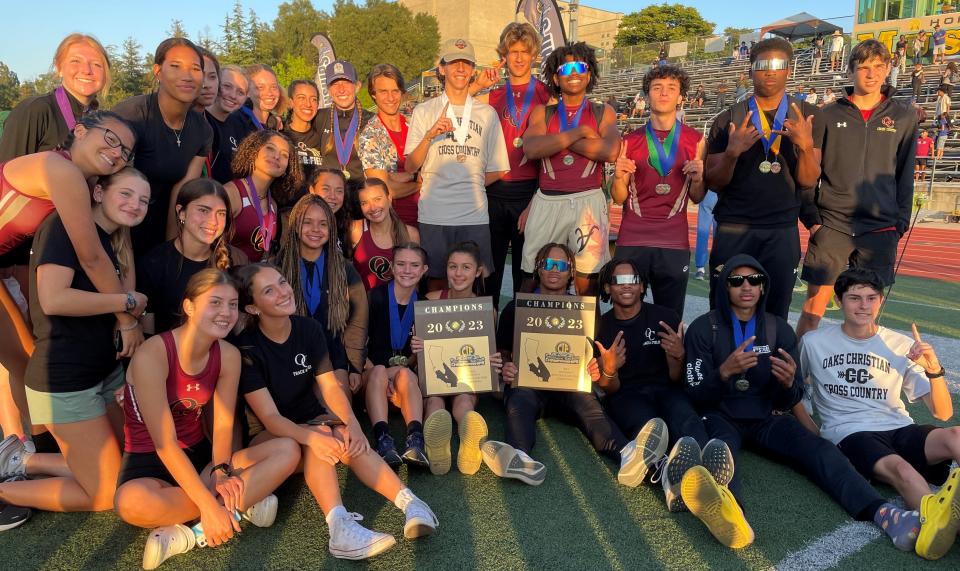 The Oaks Christian School track and field teams pose with their CIF-Southern Section championship plaques after both teams won Division 4 titles Saturday at Moorpark High.