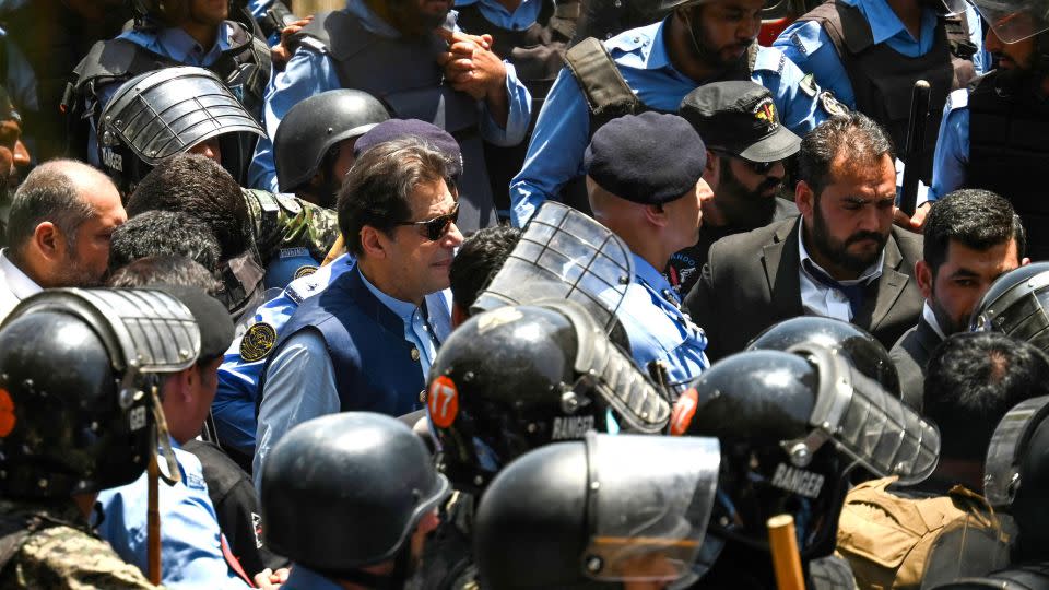 Policemen escort Khan as he arrives for a bail hearing at the high court in Islamabad on May 12, 2023. - Aamir Qureshi/AFP/Getty Images
