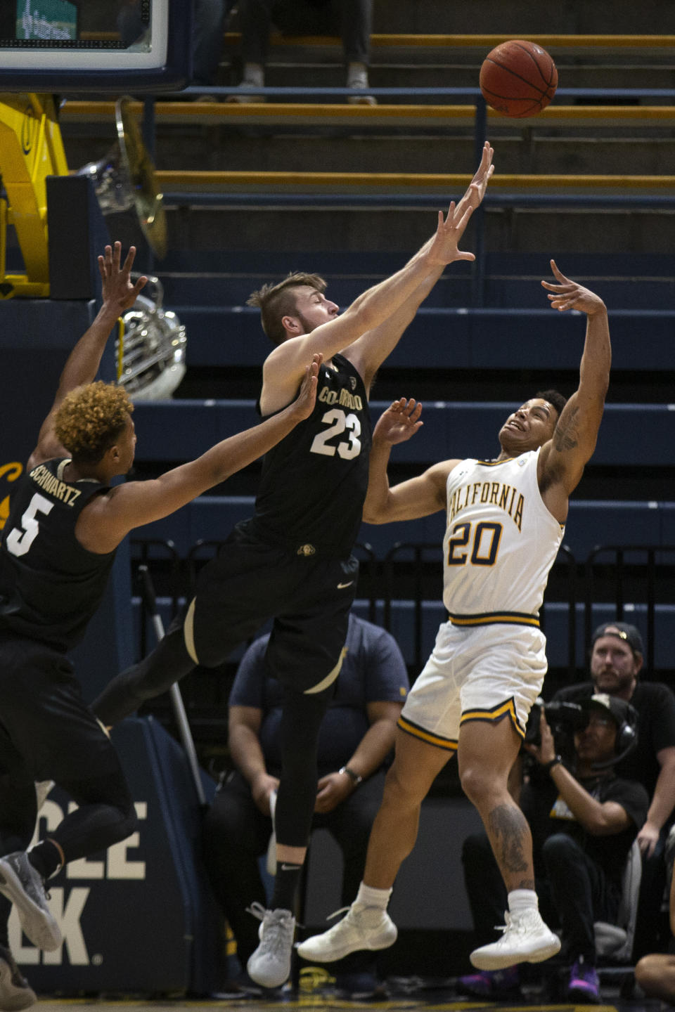 California guard Matt Bradley (20) shoots over Colorado defenders D'Shawn Schwartz (5) and Lucas Siewert (23) during the first half of an NCAA college basketball game Thursday, Feb. 27, 2020, in Berkeley, Calif. (AP Photo/D. Ross Cameron)