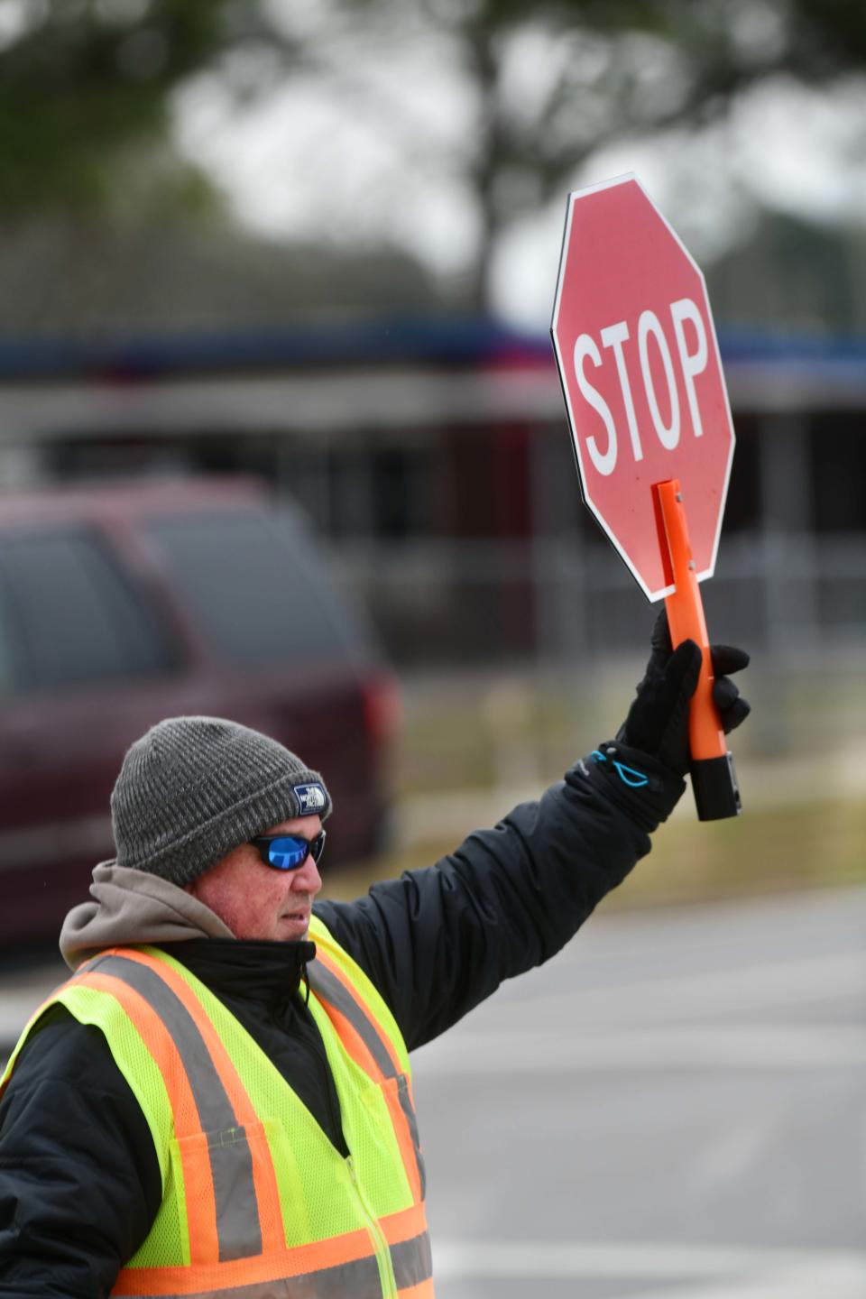 Crossing guard Jim Welch is bundled up against Friday's mid-30s temperatures as he helps students cross Hollwyood Boulevard to Edwins Elementary School.