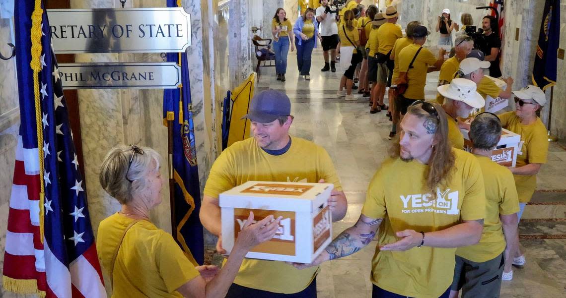 Idahoans for Open Primaries volunteers deliver boxes filled with signatures to the Idaho Secretary of State’s Office at the Capitol on Tuesday. If approved in the coming weeks, the initiative to implement open primaries and ranked-choice voting will be on the November ballot.